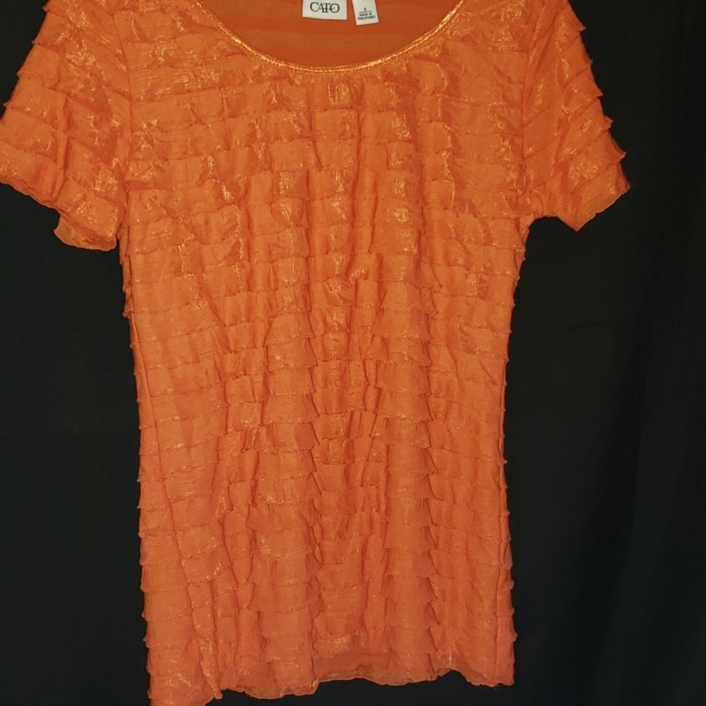 Orange ruffle, stretchy shirt.